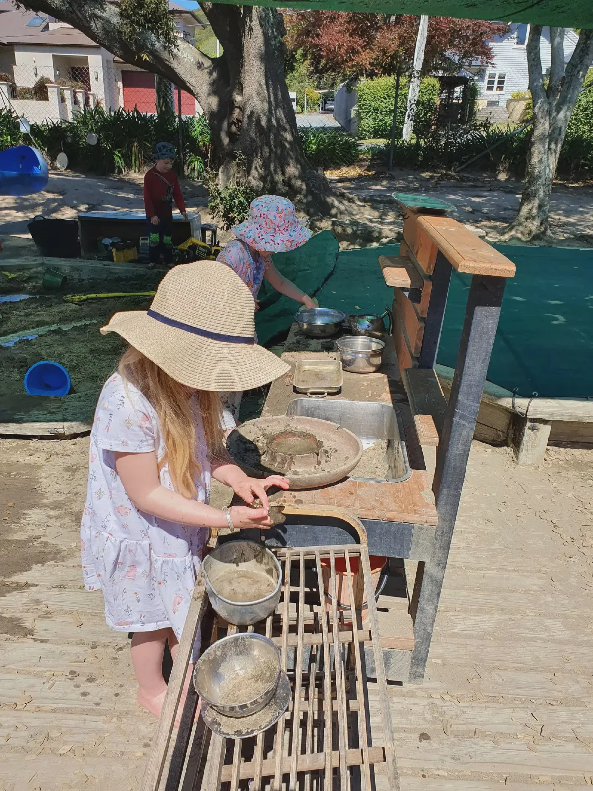 Children playing at the outdoor mud kitchen