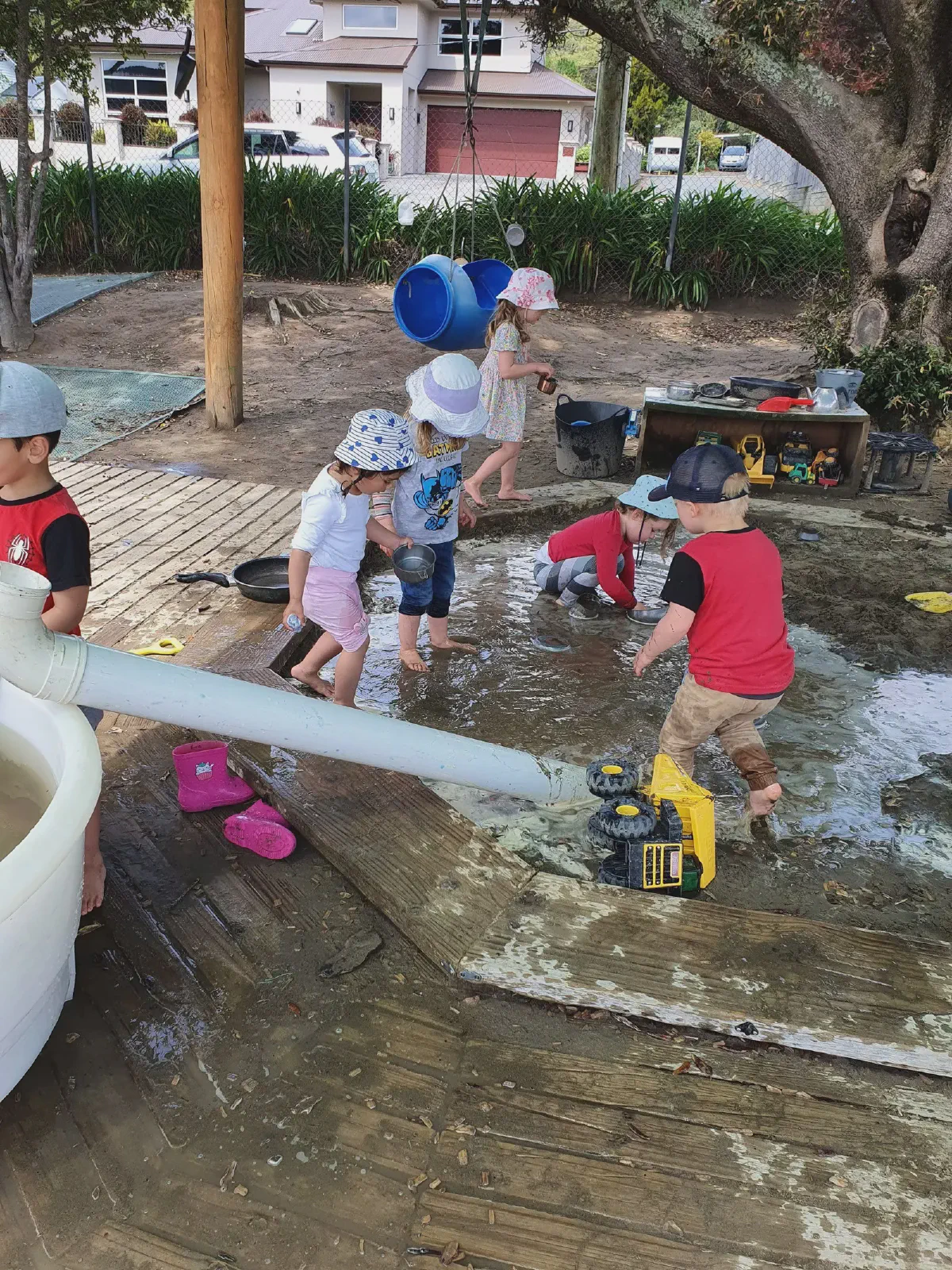Children playing with water outdoors